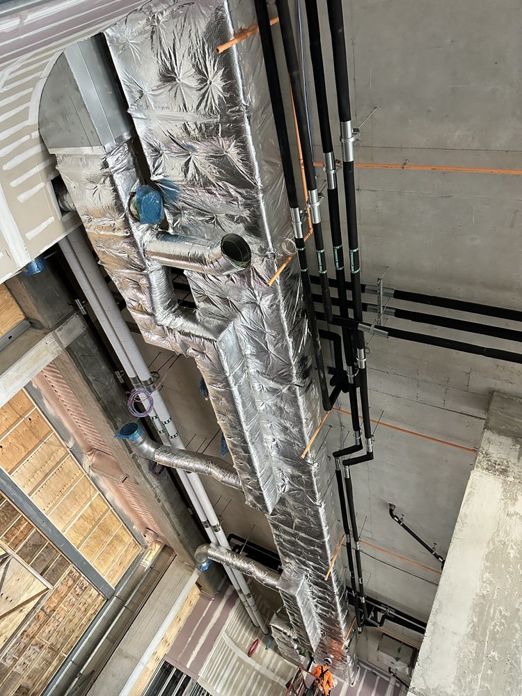 Ductwork insulation finished with FSK tape, chilled water and condensate piping in elastomeric alongside