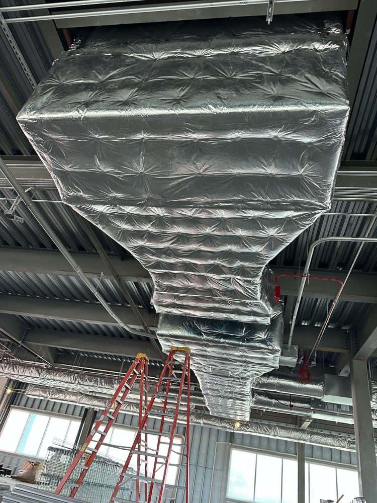 Duct wrap on supply main, open ceiling