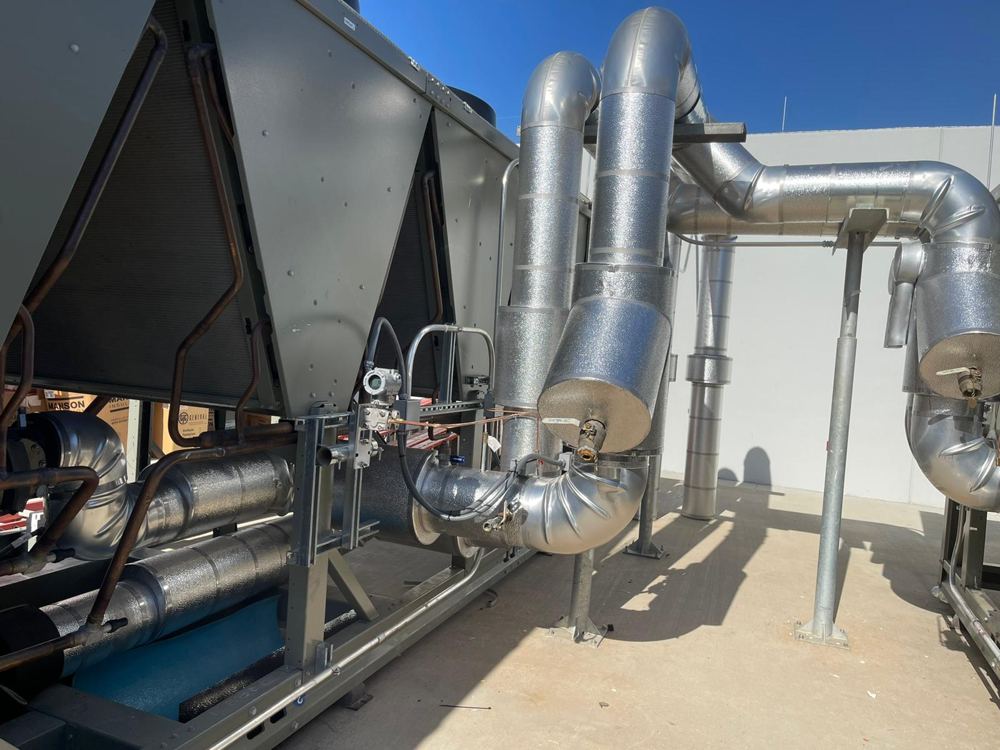 Chiller piping insulated with Foamglas and finished with aluminum jacket