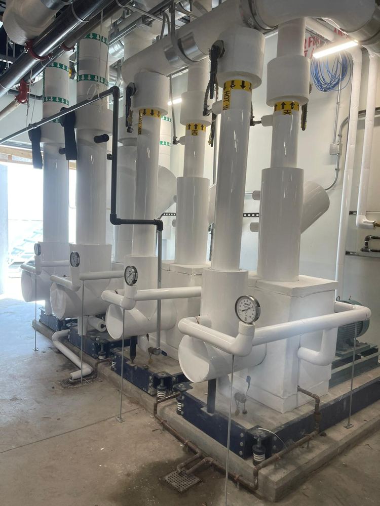 Pump headers insulated with fiberglass and finished with PVC