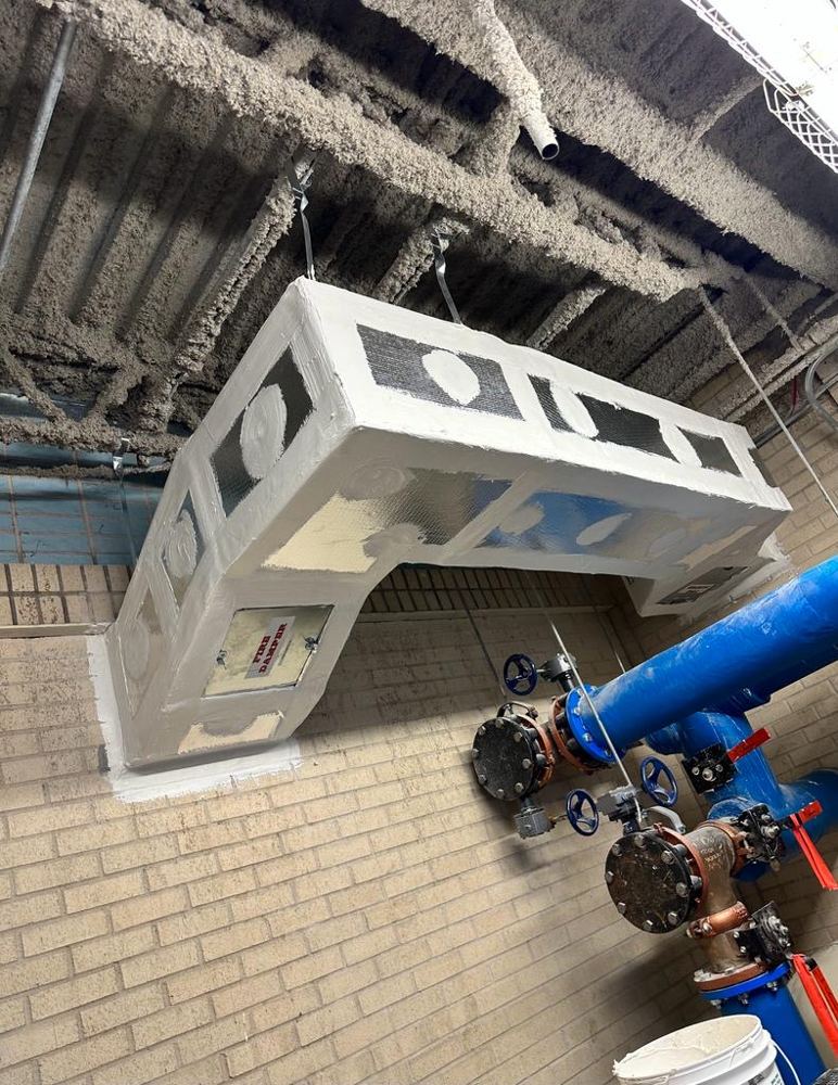 Duct insulated with ductboard insulation, finished with fab and mastic on joints, and fire damper access